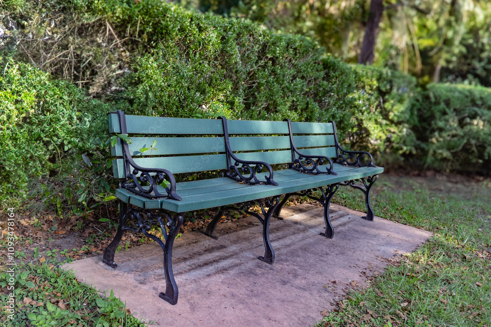 Green Park Bench with Foliage. Restful Area to Sit and Relax. Green Park Bench with Foliage. Restful Area to Sit and Relax.
