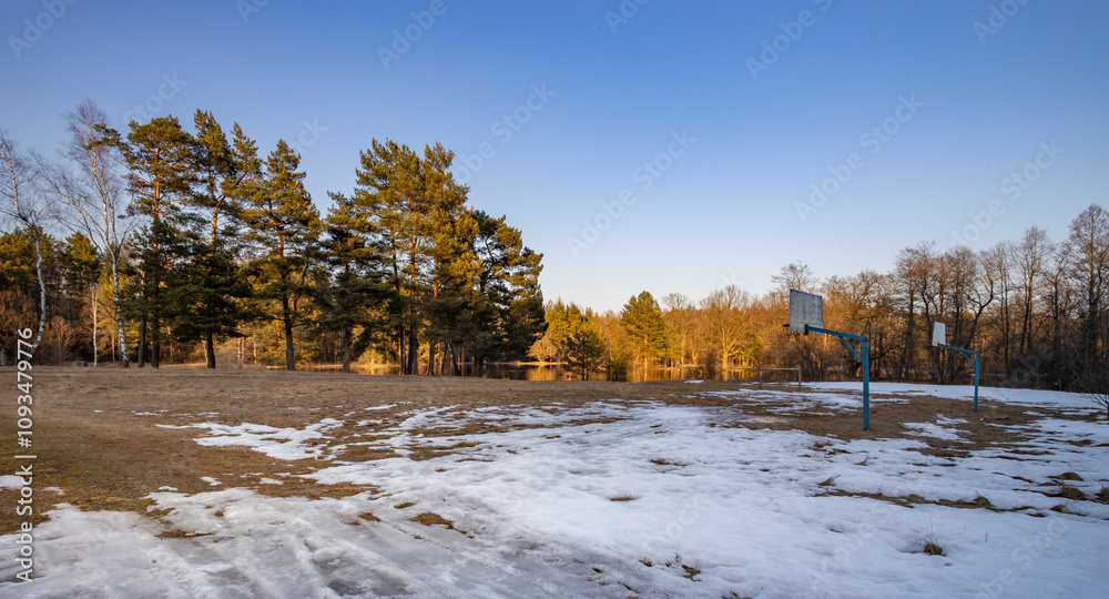 Basketball court sits in a snow-covered field Basketball court sits in a snow-covered field