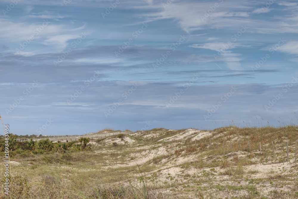 Sandy Dunes on the Eastern Coast of Florida. Blue sky with clouds. Sandy Dunes on the Eastern Coast of Florida. Blue sky with clouds.