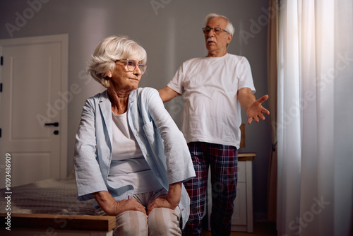 Senior woman having  argument with her husband in bedroom. photo