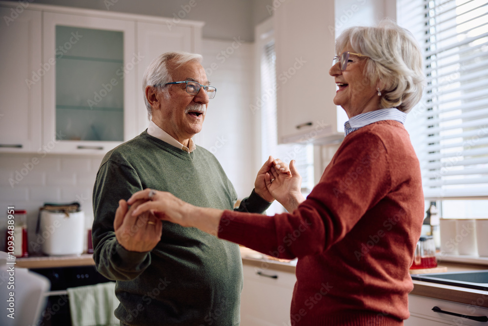 Fototapeta premium Happy senior man dancing with his wife at home.