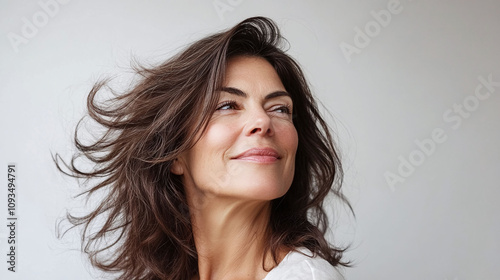 Middle-aged woman struggling with increased shedding and difficulty styling her thinning hair