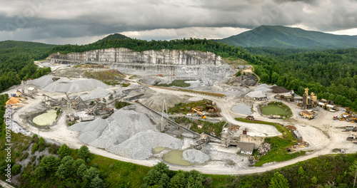 Aerial view of open pit mining site of limestone materials extraction for construction industry