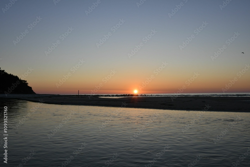 Serene sunset over a calm beach Serene sunset over a calm beach