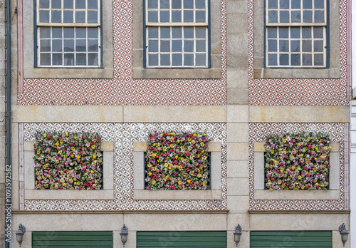 A facade of a building with fake flowers in Porto, Portugal