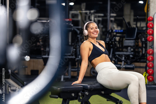 Smiling caucasian female athlete exercising in the gym.