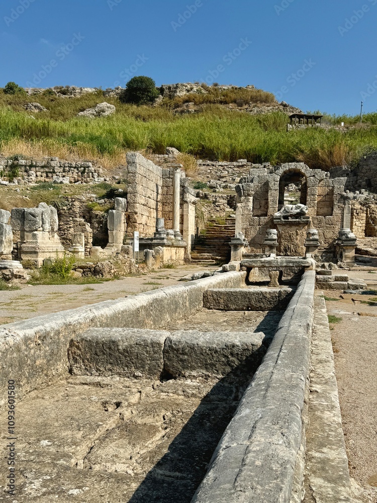 The main street with fountain in the ancient city of Perge Ruins in Turkey