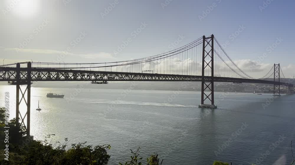 Silhouette view of the 25 April Bridge crossing Tagus River at sunset in Lisbon - Almada, Portugal Silhouette view of the 25 April Bridge crossing Tagus River at sunset in Lisbon - Almada, Portugal
