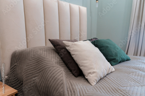 A large bed with a bedspread and pillows. photo