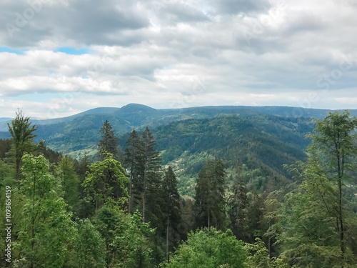 A mountain range with a cloudy sky in the background