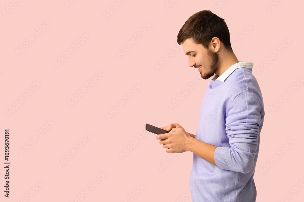 Young man using mobile phone on pink background. Online dating concept Young man using mobile phone on pink background. Online dating concept