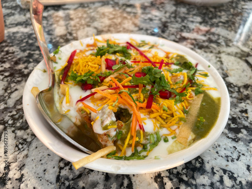 Indian Chaat with Curd, Sweet Sauce and many other ingredients served in a plate photo