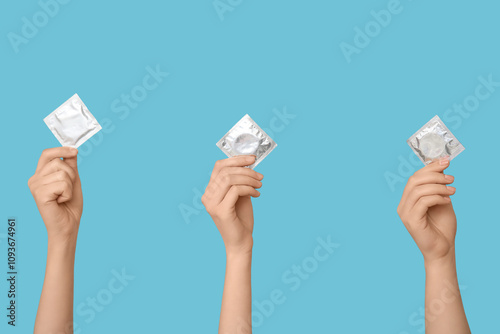 Female hands with condoms o...