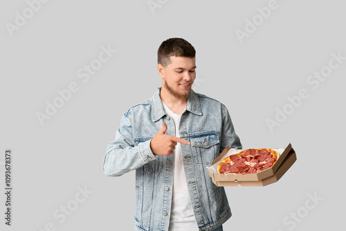 Young man pointing at cardb...
