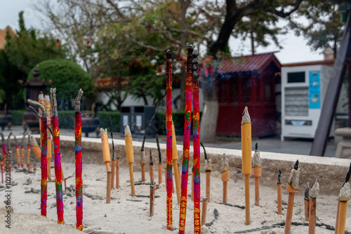 Colorful incence in the Sand photo