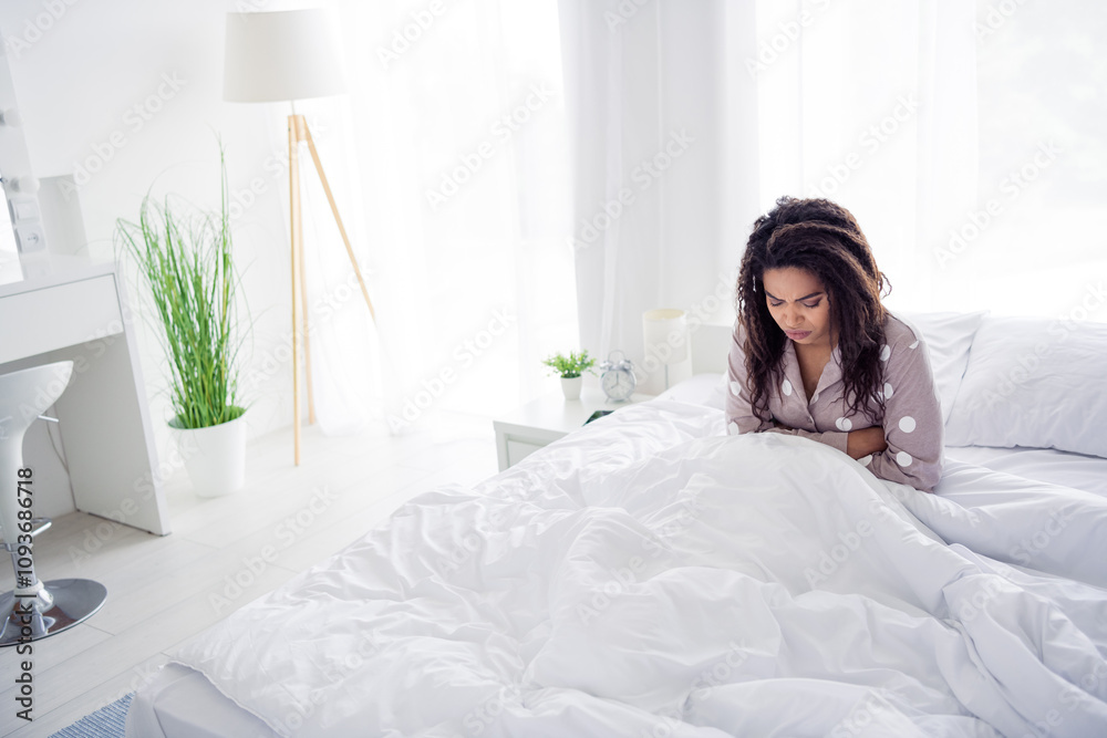 Young woman in sleepwear relaxing in a cozy bedroom with natural light and a peaceful atmosphere Young woman in sleepwear relaxing in a cozy bedroom with natural light and a peaceful atmosphere