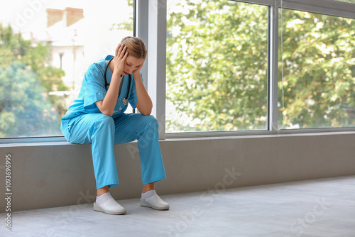 Tired female doctor with st...
