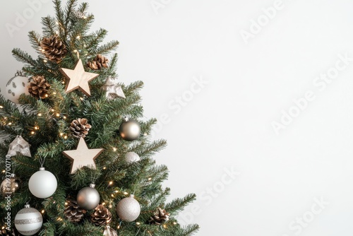 decorated Nordic Christmas tree with minimalist ornaments and natural elements like pinecones and wooden stars, minimal white gray background with copy space photo