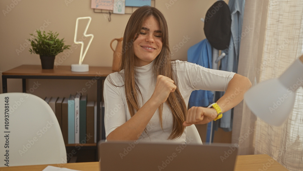 Happy young woman celebrating success at home office with laptop Happy young woman celebrating success at home office with laptop