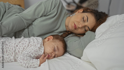 Mother and baby sleeping peacefully together in a cozy bedroom, capturing the essence of family love and intimate bonding during a serene indoor moment.