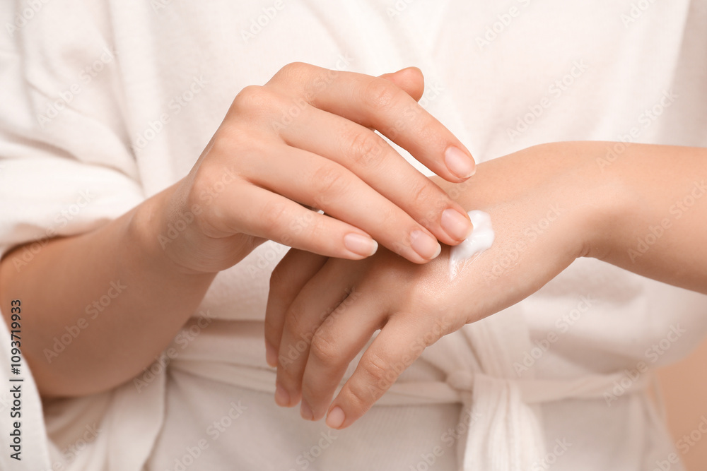 Young woman applying cosmetic cream on her hand, closeup Young woman applying cosmetic cream on her hand, closeup