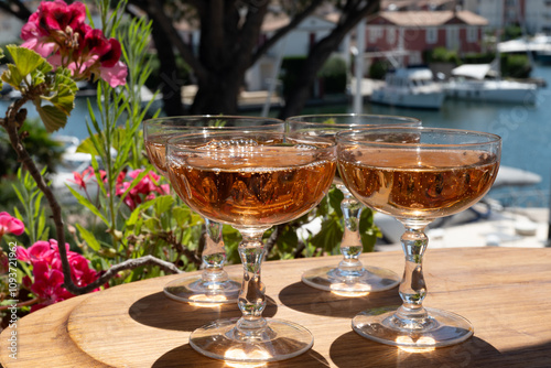 Summer party, French brut rose champagne sparkling wine in coupe glasses in yacht harbour of Port Grimaud near Saint-Tropez, French Riviera vacation, Var, France photo