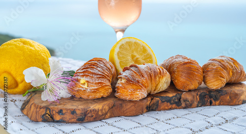 Italian desssert, Naples sfogliatella, shell-shaped layered pastry, with sweet custard-like filling made with semolina, ricotta, and candied citrus fruit and glass of ose wine and seaview