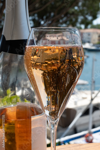 Summer party, French brut rose champagne sparkling wine in flute glasses in yacht harbour of Port Grimaud near Saint-Tropez, French Riviera vacation, Var, France photo