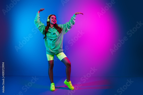 Full length photo of cheerful pretty lady dressed sweatshirt earphones having disco fun empty space isolated neon pink color background