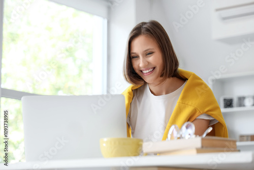 Teenage girl filling out college application form at home