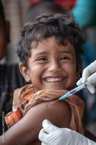 Happy Indian kid getting vaccine. Children vaccination, childhood immunization. Smiling little boy at the hospital or doctor’s office is getting vaccine