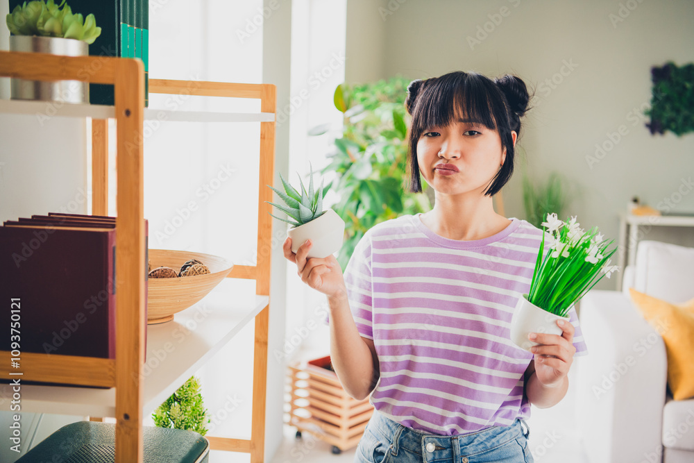 Photo of adorable doubtful lady wear violet striped t-shirt choosing home decor indoors room home house Photo of adorable doubtful lady wear violet striped t-shirt choosing home decor indoors room home house