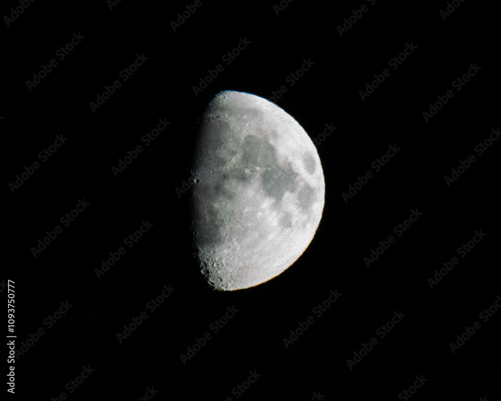 Close up of the half moon illuminating the night sky, creating a dramatic and mysterious atmosphere Close up of the half moon illuminating the night sky, creating a dramatic and mysterious atmosphere