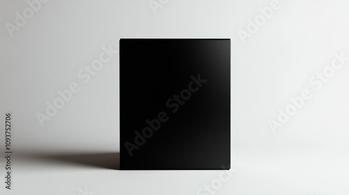 A sleek matte black box with a simple design, standing upright on a plain white backdrop 