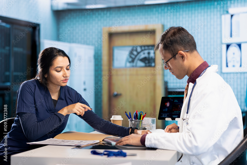 Obraz premium Professional doctor and patient engage in a medical consultation for a scan interpretation of x ray and MRI results. General practitioner emphasizing healthcare practices and medical research.