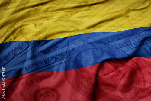 waving colorful flag of colombia on the dollar money background. finance concept. photo