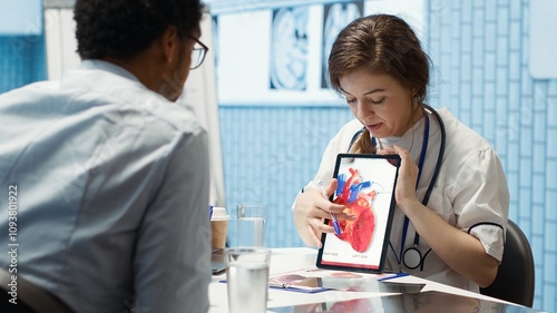 фотографія Healthcare provider cardiologist explains heart function on a cardiogram, doctor patient interaction in a medical office
