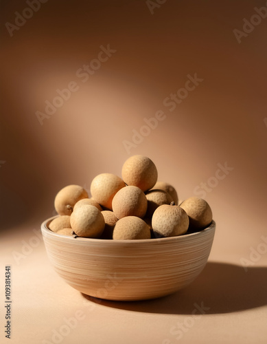 Fresh Longan fruit in a bowl on Pastel light brown background