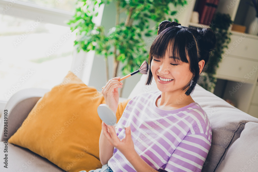 Photo of pretty cheerful lady wear striped violet t-shirt applying powder indoors room home house Photo of pretty cheerful lady wear striped violet t-shirt applying powder indoors room home house
