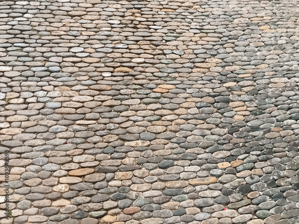 A stone wall with a pattern of small stones A stone wall with a pattern of small stones