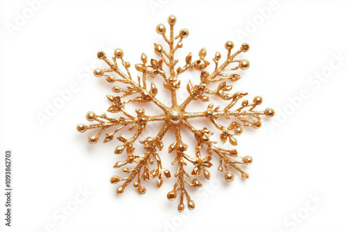 Glittering golden snowflake ornament on a white background