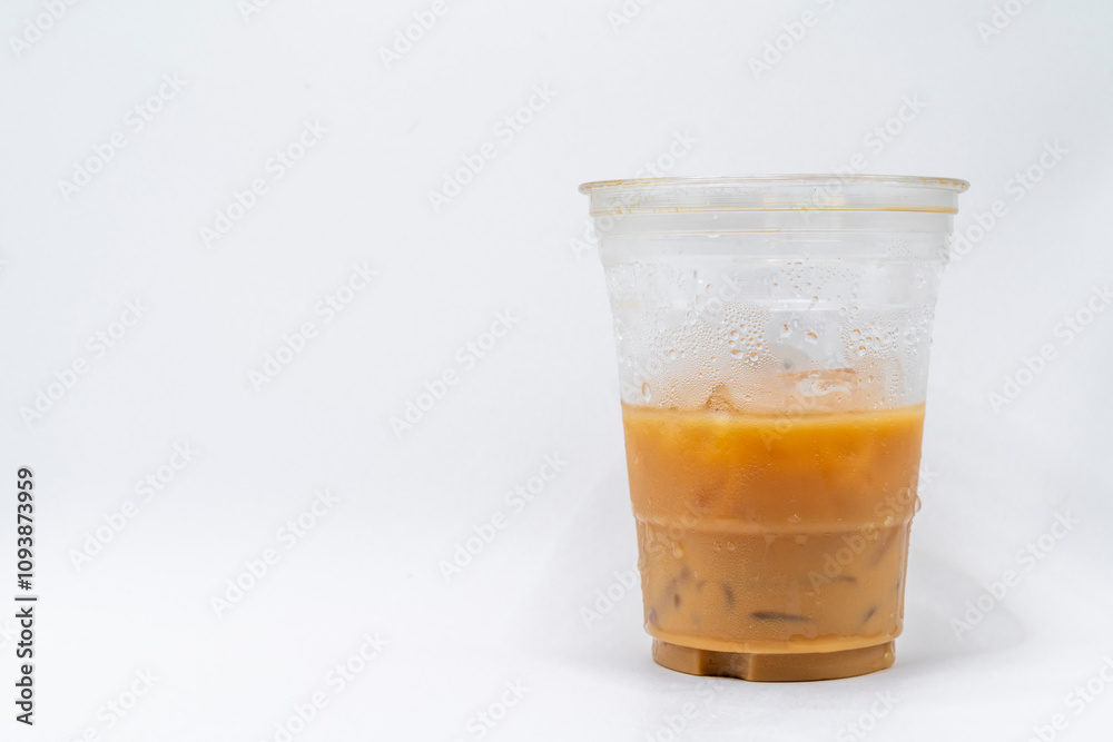 Iced caramel macchiato in a plastic cup, showing the beautiful swirls of coffee, milk, and caramel isolated Iced caramel macchiato in a plastic cup, showing the beautiful swirls of coffee, milk, and caramel isolated