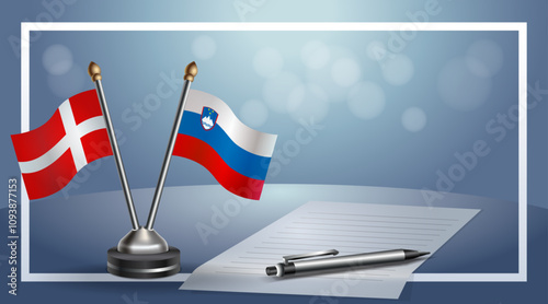 Denmark and Slovenia National flags on small table with bokeh background, cooperative relationship
