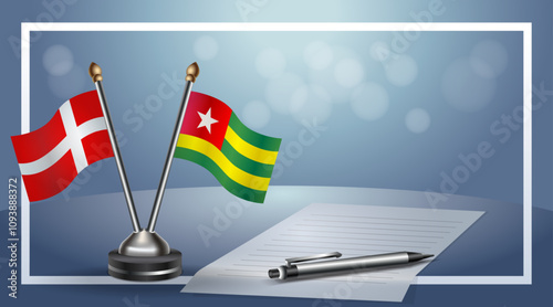 Denmark and  Togo National flags on small table with bokeh background, cooperative relationship