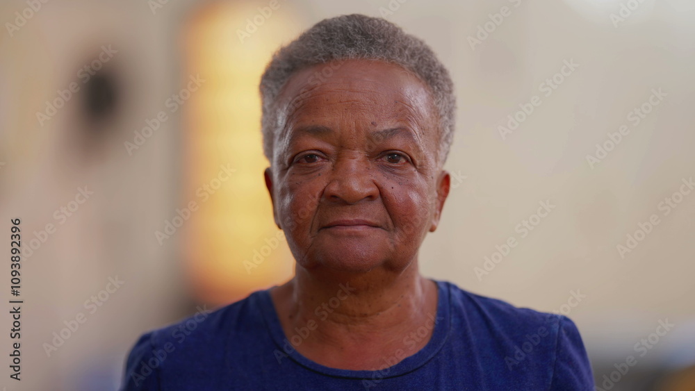 Portrait of a Brazilian black senior woman with neutral expression looking at camera. Close-up face of an African American elderly female person Portrait of a Brazilian black senior woman with neutral expression looking at camera. Close-up face of an African American elderly female person