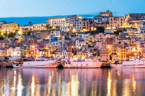 Italy, Sicily, Agrigento Province, Sciacca. April 16, 2019. Fishing boats at night in the harbor of Sciacca, on the Mediterranean Sea.