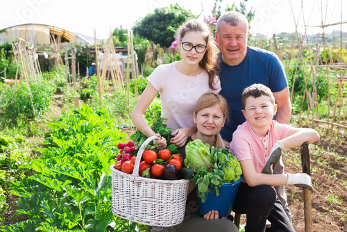 Wallpaper Mural Parents with children posing with a basket of ripe vegetables in the garden Torontodigital.ca
