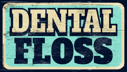 Aged and worn dental floss sign on wood