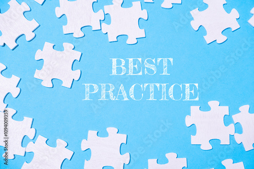 Blue background with white puzzle pieces scattered around it photo