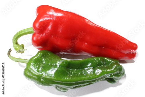 One red pepper and one green pepper on a white background